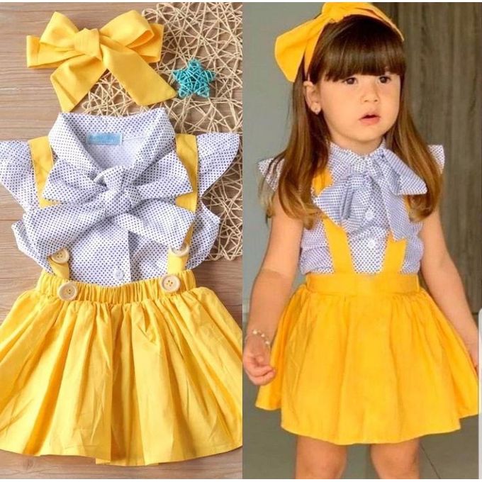 Conjunto dos piezas, falta amarilla y blusa blanca con puntitos negros y vincha amarilla